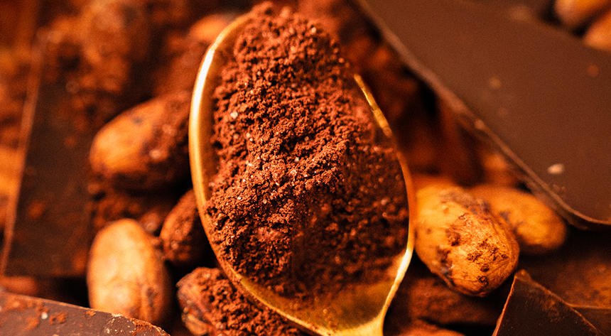 Spoon being dipped into hot chocolate powder