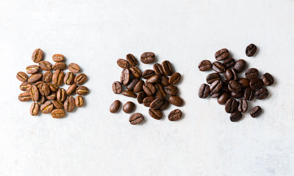 Light, Medium and Dark Roasted Coffee Beans on Table Top